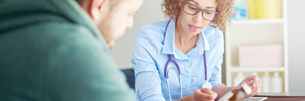 Provider holding Rx with patient